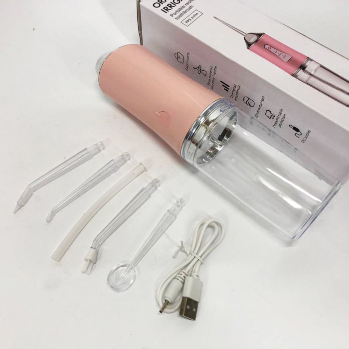 Ирригатор для чистки зубов и полости рта Oral Irrigator с аккумулятором и сменными насадками. Цвет: розовый